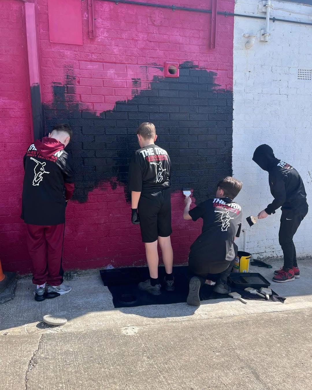 A group painting one of our walls