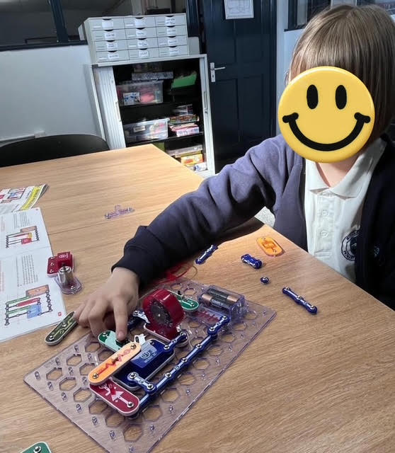 A young person learning basic electronics